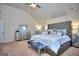 Comfortable main bedroom features a tufted headboard and sitting area at 1058 Hartwell Rd, Locust Grove, GA 30248