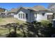 Backyard view of white home siding with a wooden fence and grassy yard at 325 Autumn Glen Cir, Fayetteville, GA 30215