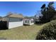 Backyard view with fenced perimeter and white home exterior under a clear blue sky at 325 Autumn Glen Cir, Fayetteville, GA 30215