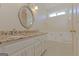 Well-lit bathroom features double vanity with granite countertop, large oval mirror, and soaking tub at 325 Autumn Glen Cir, Fayetteville, GA 30215