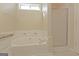 Bright bathroom shows corner tub with decorative tile accents and a shower with sliding glass door at 325 Autumn Glen Cir, Fayetteville, GA 30215