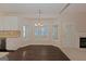 Bright dining area featuring a bay window, elegant lighting, and easy access to the kitchen and fireplace at 325 Autumn Glen Cir, Fayetteville, GA 30215