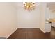 Bright dining room with wood floors, decorative chandelier, and easy access to the kitchen at 325 Autumn Glen Cir, Fayetteville, GA 30215