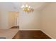 Dining room with hardwood floors, decorative chandelier, and a view into another room at 325 Autumn Glen Cir, Fayetteville, GA 30215