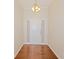 Inviting foyer with hardwood floors, chandelier, and a view of the front door with sidelight windows at 325 Autumn Glen Cir, Fayetteville, GA 30215