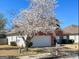 Charming one-story red brick home with well-manicured lawn, flowering trees, and a two-car garage at 325 Autumn Glen Cir, Fayetteville, GA 30215