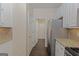Bright kitchen with granite countertops, white cabinets, stainless steel appliances, and hardwood flooring at 325 Autumn Glen Cir, Fayetteville, GA 30215