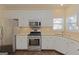 Functional kitchen with stainless steel appliances, granite counters, and lots of cabinet space at 325 Autumn Glen Cir, Fayetteville, GA 30215