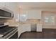 Modern kitchen with stainless appliances, granite counters, tile backsplash, and hardwood floors at 325 Autumn Glen Cir, Fayetteville, GA 30215