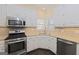 Well-appointed kitchen featuring stainless steel appliances, granite countertops, and ample cabinet space at 325 Autumn Glen Cir, Fayetteville, GA 30215