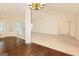 Spacious living room boasts vaulted ceilings, ceiling fan, and a seamless transition from wood to carpeted floors at 325 Autumn Glen Cir, Fayetteville, GA 30215