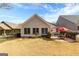 Wide view of the backyard with patio, landscaping, neighboring homes, and a black fence at 365 Grand Teton Cir, Fayetteville, GA 30215