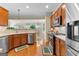 Well-equipped kitchen boasts stainless steel appliances and wood cabinets at 365 Grand Teton Cir, Fayetteville, GA 30215