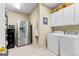 Laundry room with a stainless steel refrigerator and white washer and dryer at 365 Grand Teton Cir, Fayetteville, GA 30215