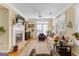 Open concept living room features a fireplace, hardwood floors, lots of natural light, and a ceiling fan at 365 Grand Teton Cir, Fayetteville, GA 30215