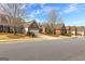 Exterior view of several brick homes lining a quiet street on a sunny day at 365 Grand Teton Cir, Fayetteville, GA 30215