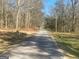 Tree-lined street offering a serene approach to the property with bare winter trees at 405 W Richardson Rd, Oxford, GA 30054