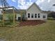 Well-maintained backyard featuring a garden area with mulched beds and a charming wooden pergola at 248 Valley Way, Hampton, GA 30228