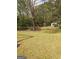 Picturesque backyard features a shed with double doors and adjacent storage, surrounded by trees at 248 Valley Way, Hampton, GA 30228