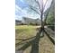 Spacious backyard featuring a pergola, mature trees, and well-kept lawn at 248 Valley Way, Hampton, GA 30228