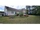 Lush backyard with a wooden pergola structure and thriving garden beds at 248 Valley Way, Hampton, GA 30228