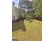 Backyard featuring a wooden pergola and landscaped garden area with flowers at 248 Valley Way, Hampton, GA 30228