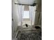 Bathroom featuring a soaking tub with curtain accents, and a large decorative rug at 248 Valley Way, Hampton, GA 30228