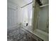 Bathroom featuring a tub with curtain, a large decorative rug, and a glass shower at 248 Valley Way, Hampton, GA 30228