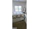 Bedroom with neutral walls and carpet flooring, featuring a bed and large window for natural light at 248 Valley Way, Hampton, GA 30228