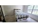 Bedroom showcasing a cozy bed with a floral quilt, complemented by natural light from a nearby window at 248 Valley Way, Hampton, GA 30228