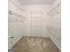 Walk-in closet with carpet flooring and multiple rows of white wire shelving providing ample storage space at 248 Valley Way, Hampton, GA 30228