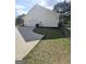 Attached garage with white siding and a concrete driveway with a view of backyard at 248 Valley Way, Hampton, GA 30228