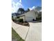 Side view of home featuring an attached garage and well-maintained landscaping at 248 Valley Way, Hampton, GA 30228