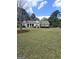 Well-maintained single-story home with a spacious front lawn and mature trees at 248 Valley Way, Hampton, GA 30228
