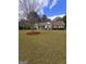 Landscaped front yard showcasing the single-story brick home and large shade tree at 248 Valley Way, Hampton, GA 30228