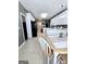 Bright eat-in kitchen featuring white appliances, tile flooring, and a cozy breakfast area at 248 Valley Way, Hampton, GA 30228