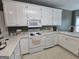 Spacious kitchen with white appliances, light countertops, and lots of cabinet space at 248 Valley Way, Hampton, GA 30228