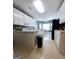 Kitchen showcasing white cabinets, ample counter space and a dining area with natural light at 248 Valley Way, Hampton, GA 30228