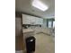 Updated kitchen with white appliances, plenty of cabinets, and view of a sunlit breakfast area at 248 Valley Way, Hampton, GA 30228