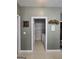 A glimpse into the tiled laundry room featuring a white washer and dryer and wire shelving at 248 Valley Way, Hampton, GA 30228