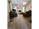 Comfortable living room with fireplace, ceiling fan, and neutral carpet at 248 Valley Way, Hampton, GA 30228