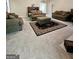 Spacious living room with neutral carpet, plush furniture, and a decorative area rug at 248 Valley Way, Hampton, GA 30228
