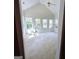 Bright sun room featuring vaulted ceiling, neutral carpet, and a view of the yard at 248 Valley Way, Hampton, GA 30228