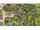 Aerial view of the home in its wooded setting in a suburban neighborhood at 1022 Miss Amber Way, Locust Grove, GA 30248
