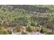 Aerial view showcasing the home's placement on a wooded lot in a quiet neighborhood at 1022 Miss Amber Way, Locust Grove, GA 30248