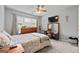 Cozy carpeted bedroom offering soft natural light and a ceiling fan at 1022 Miss Amber Way, Locust Grove, GA 30248