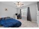 Simple bedroom with neutral colors, a ceiling fan, and a window with natural light at 1022 Miss Amber Way, Locust Grove, GA 30248