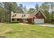 Charming one-story brick home features a manicured lawn and attached two-car garage at 1022 Miss Amber Way, Locust Grove, GA 30248