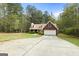 Charming brick home features a spacious driveway and an attached two-car garage at 1022 Miss Amber Way, Locust Grove, GA 30248