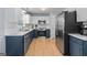 Modern kitchen with stainless steel appliances, white counters, and dark blue cabinets at 1022 Miss Amber Way, Locust Grove, GA 30248